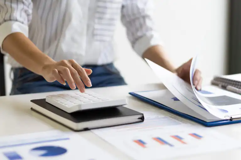 Person using calculator and papers