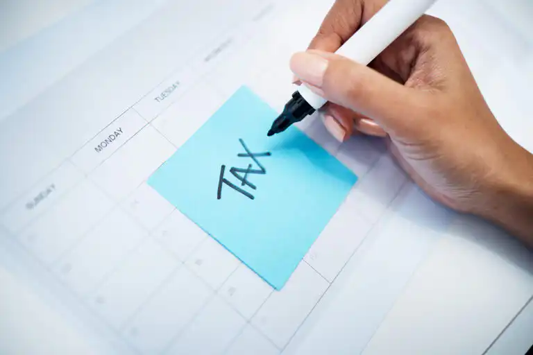 Hand writing TAX on note